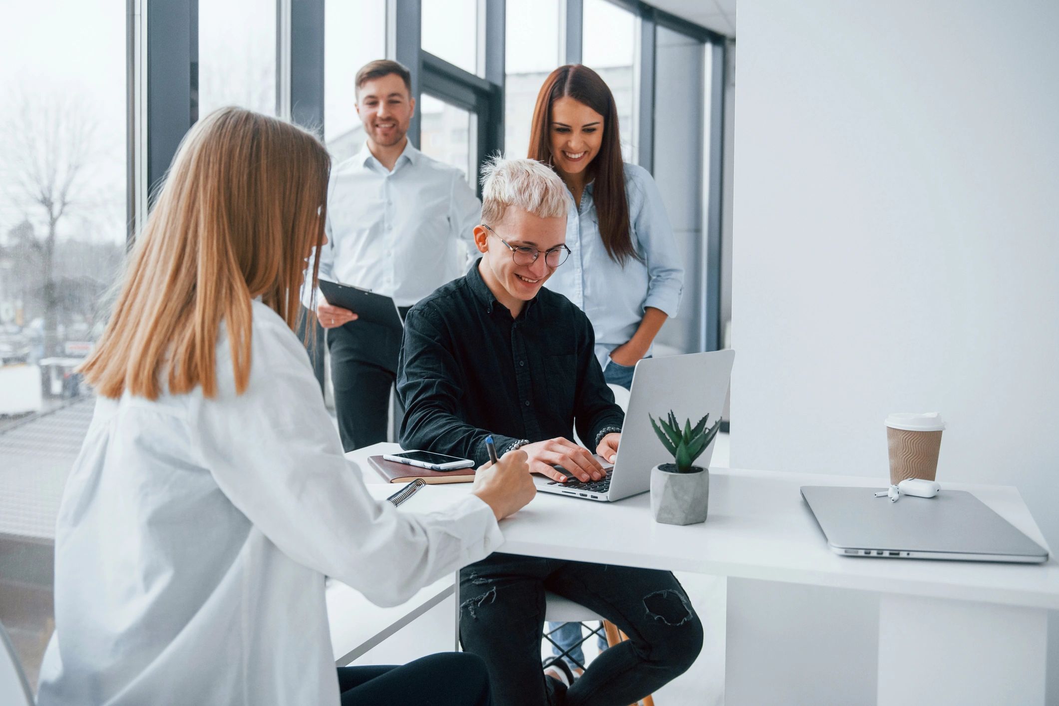 Colleagues working together at a laptop in an office
