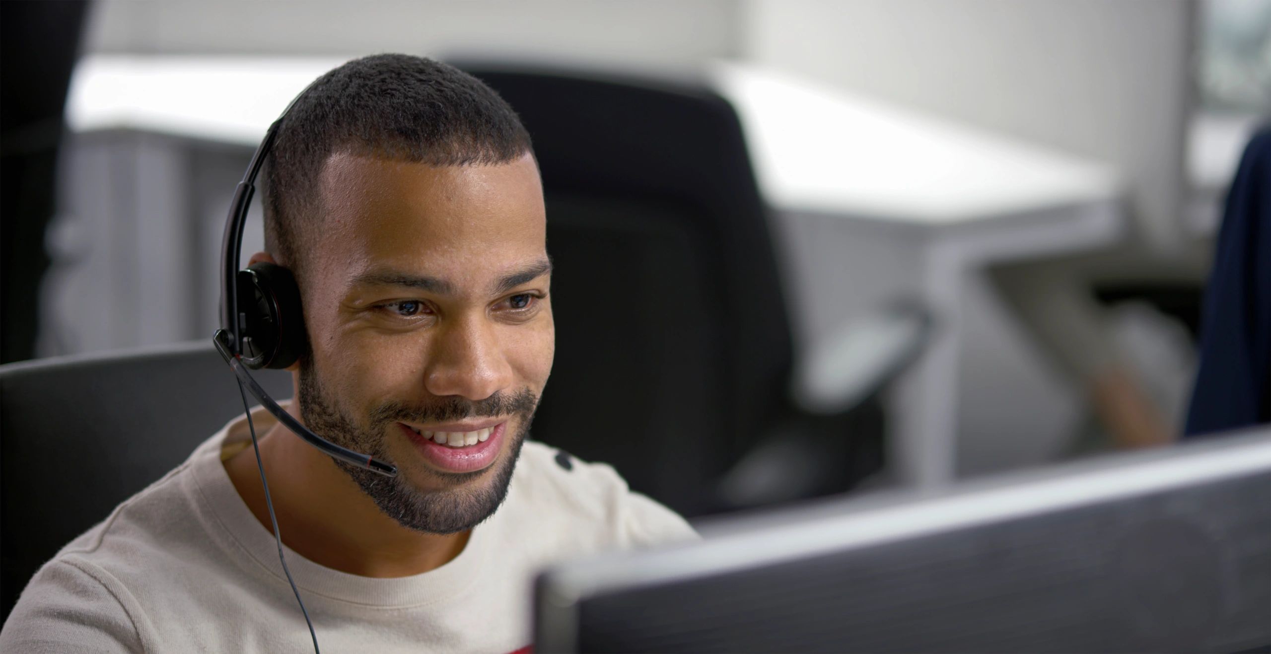 Businessman speaking with a headset microphone in an office